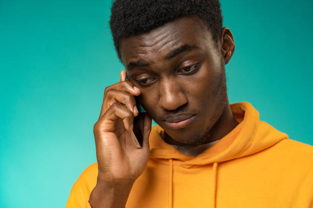 istock Black man with a sad face talking on the phone in studio 1385727892