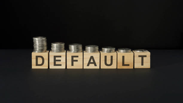 istock DEFAULT word concept on wooden blocks on a black table with coins 1385729965