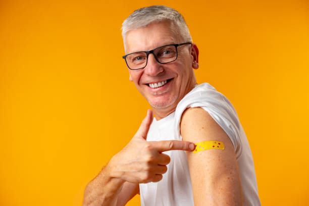 istock Senior man against yellow background recieved corona virus vaccination 1385730268