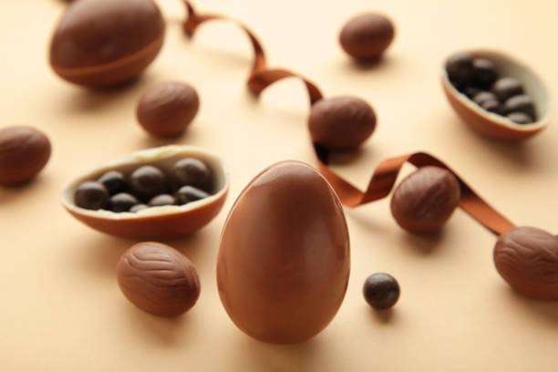 istock Easter composition with chocolate eggs and brown ribbon on beige background 1385730557