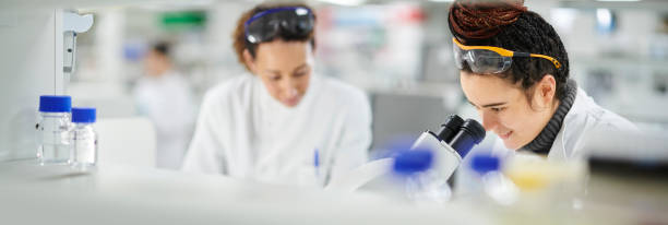 istock young female biochemist with microscope 1385730567