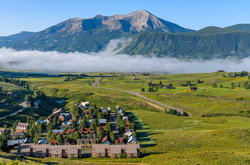 A foggy Summer morning view of mountain town Crested Butte at base of Whetstone Mountain. Colorado, USA.