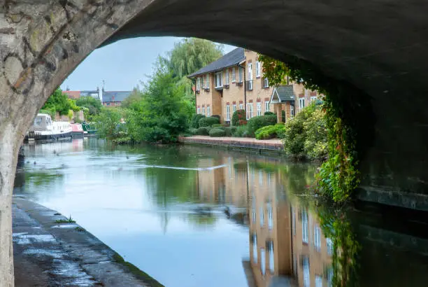 Photo of Reflection under a bridge in the Grand Union Canal, England.