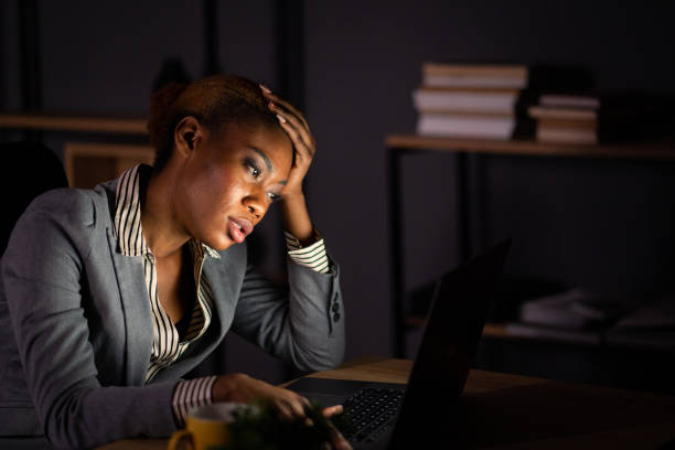 istock A tired female secretary working late at night 1385734183