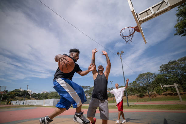 istock playing basketball in the park 1385734368