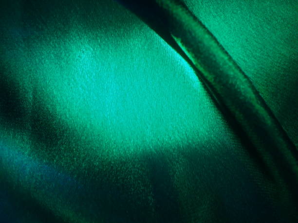 istock Green  silk satin luxury fabric background with copy space  background 1385735740