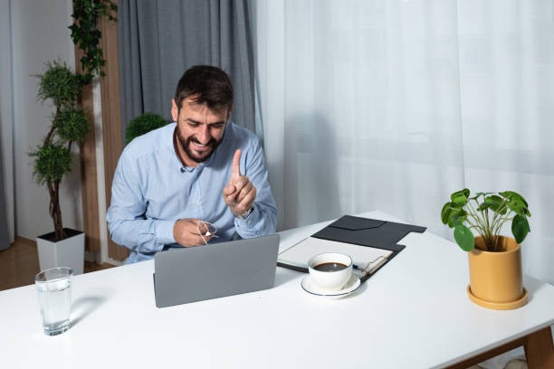 istock Young satisfied expert freelancer business man preparing video call presentation on his laptop with company employees explaining ideas and solutions for successful leadership in the market strategy 1385736735