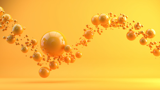 Many orange spheres falling on a orange background. 3d rendering