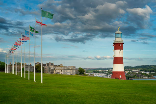 Europian flags and lighthouse of Smeaton's Tower on Plymouth Hoe, United Kingdom stock photo