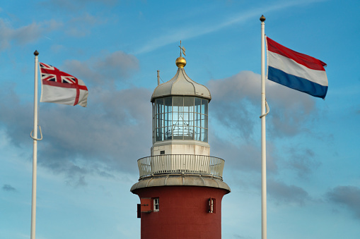 Flags and lighthouse of Smeaton's Tower on Plymouth Hoe, United Kingdom