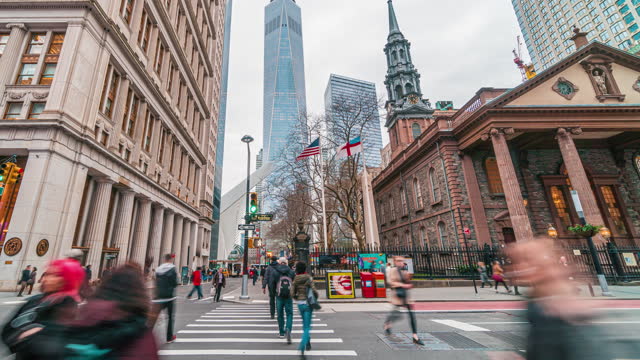 Crowd of Pedestrian walking in New York City with St. Paul's Chapel of Trinity Church in USA