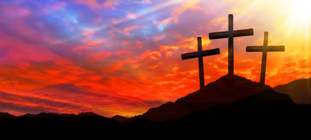 istock Easter background banner panorama religious greeting card Crucifixion and Resurrection. Three crosses of Golgotha by sunset. 1385742783