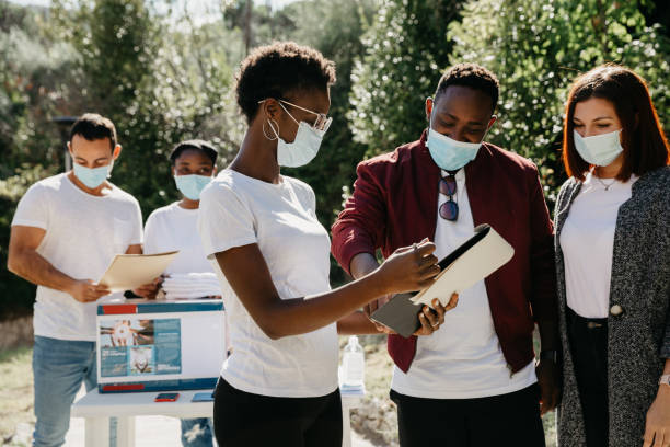 istock Group of young volunteers help the community 1385746570