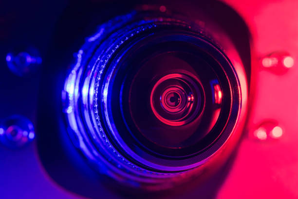 istock Camera lens with purple and red backlight. Optics. Cyberpunk style 1385748198