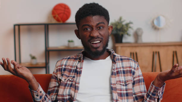 istock Confused man raising hands in indignant expression, asking why, what reason of failure at home 1385748292