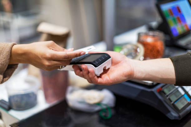 istock Man paying with credit card in zero waste shop 1385749801