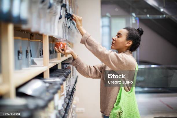 Woman Buying Food In Zero Waste Shop Stock Photo - Download Image Now - Zero Waste, Sustainable Lifestyle, Sustainable Resources