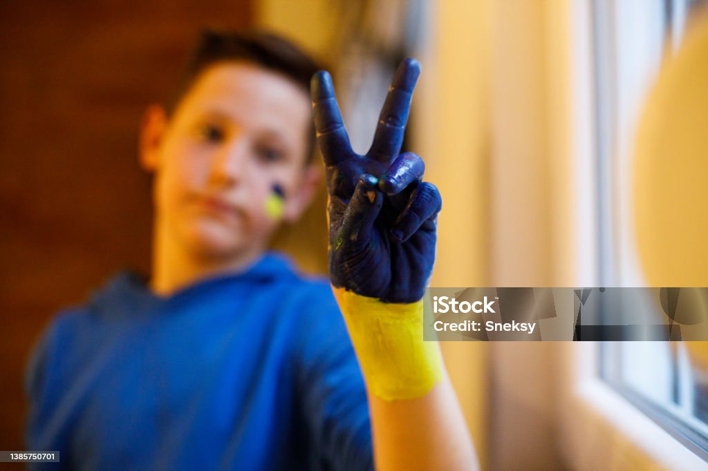 Pray for Ukraine! The boy wants peace for his friends in Ukraine. Pray for Ukraine - no war and peace concept Support Stock Photo