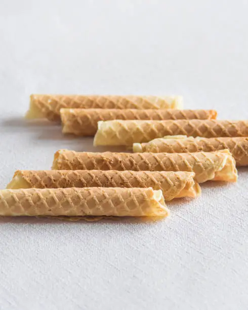 Photo of Homemade wafer rolls. Thin and Crispy Waffle. Selective focus.