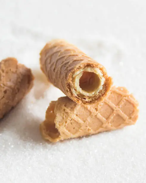 Photo of Homemade wafer rolls. Thin and Crispy Waffle. Selective focus.