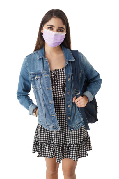 istock Beautiful young woman with mask looking at camera 1385753686