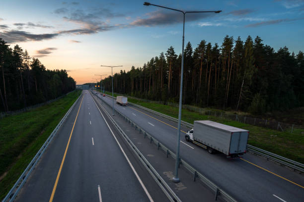 istock Trucks at multilane highway at sunset 1385754946