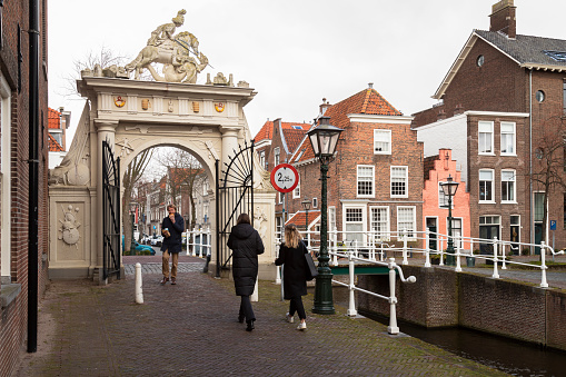 Leiden, The Netherlands, February 25, 2022; 17th century gate in the center of the historic city center of Leiden.