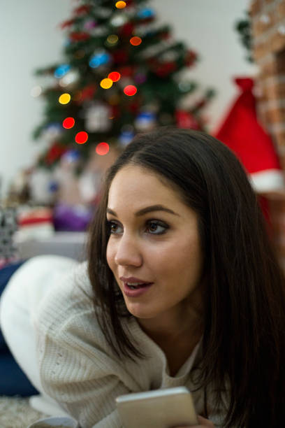 Woman celebrating Christmas wearing a Santa hat