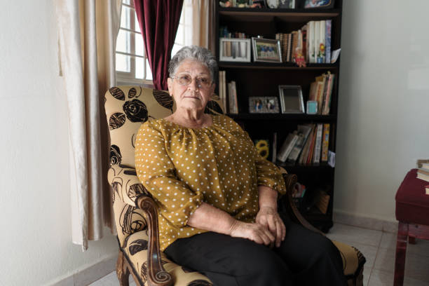 istock Senior woman sitting at home alone 1385761638