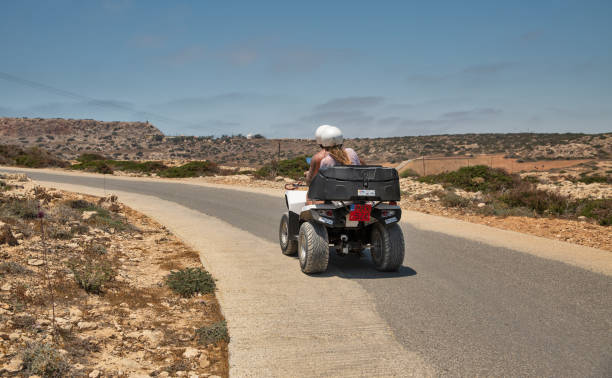 People travel on a quad bike in Ayia Napa, Cyprus. stock photo