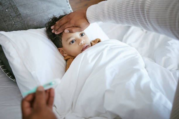 istock Cropped shot of a man checking his son's temperature 1385765872