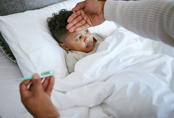 istock Cropped shot of a man checking his son's temperature 1385765873