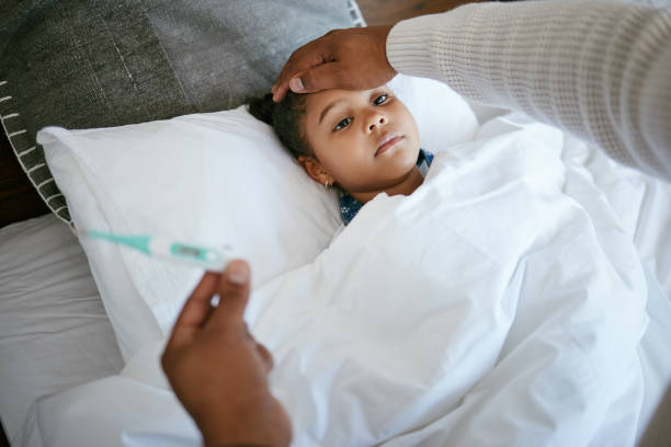 istock Cropped shot of a man checking his daughter's temperature 1385765876