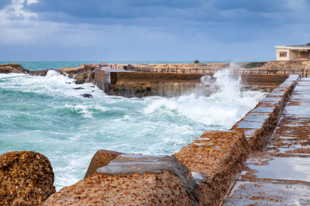 istock Coastal fortifications with waves on stormy sea 1385766492