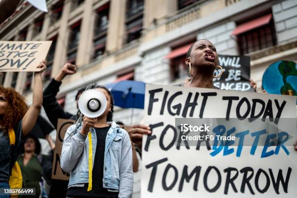 Protests Holding Signs During On A Demonstration Stock Photo - Download Image Now - Anti-racism, Protestor, Anger