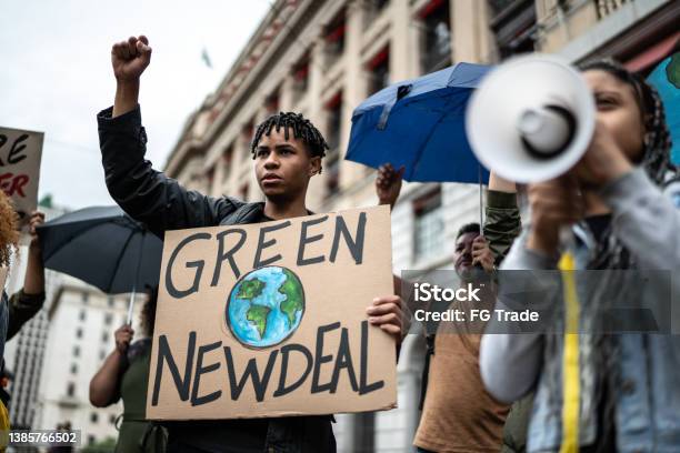 Protests Holding Signs During On A Demostration For Environmentalism Stock Photo - Download Image Now