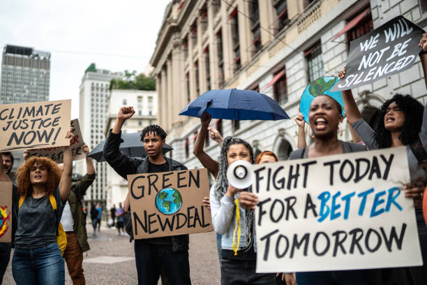 istock Protests holding signs during on a demostration for environmentalism 1385766513