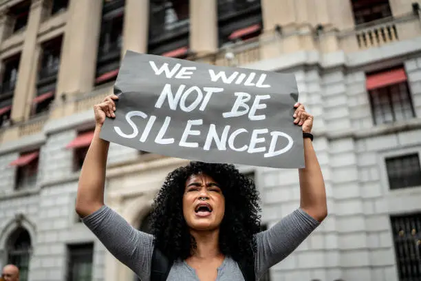 Woman holding signs during on a demonstration outdoors