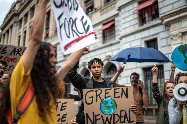 istock Protests holding signs during on a demostration for environmentalism 1385767060