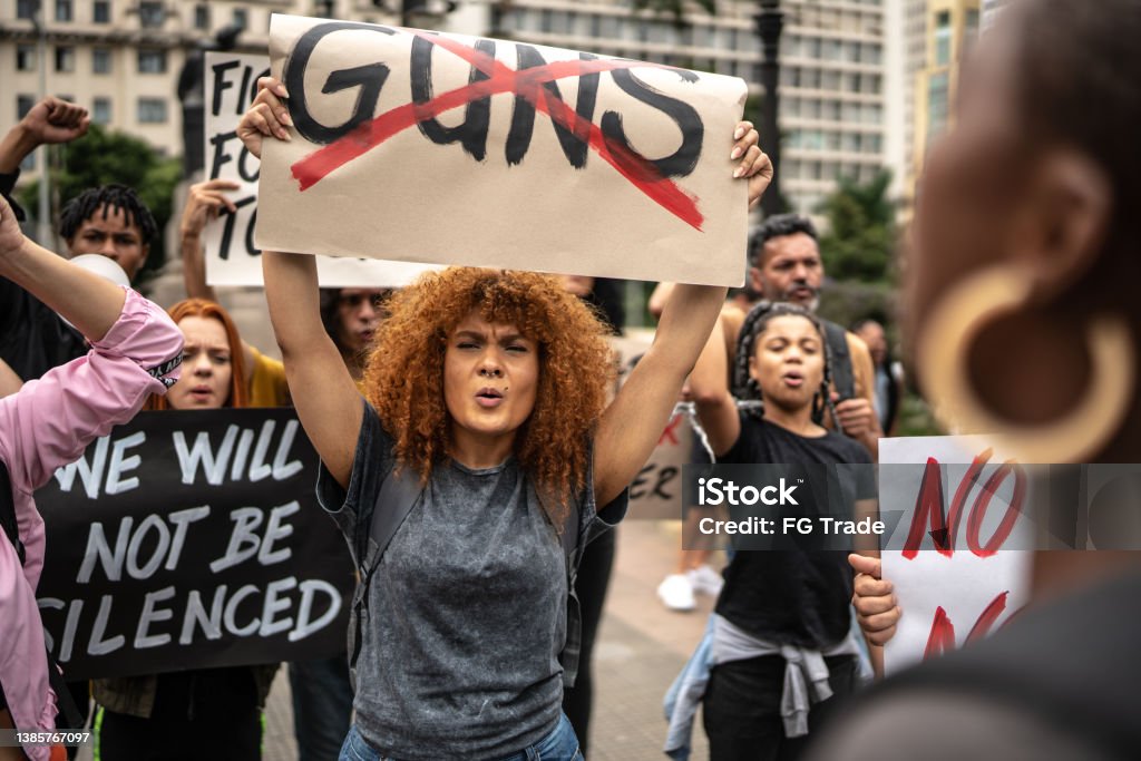 Protests holding signs during on a demonstration for peace Gun Stock Photo
