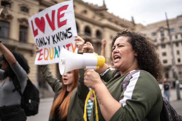 istock Woman shouting through megaphone during on a demonstration outdoors 1385767103
