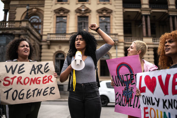 istock Woman shouting through megaphone during on a demonstration outdoors 1385767113