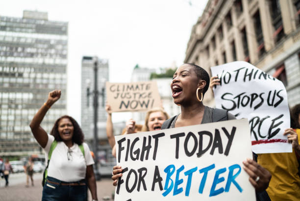 istock Woman shouting and holding sign during on a demonstration 1385767121