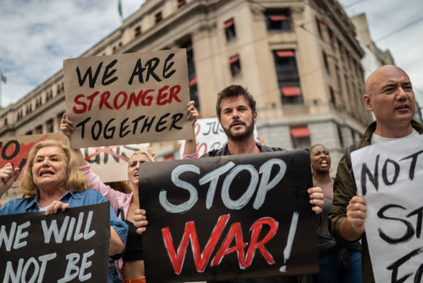 istock Protests holding signs during on a demonstration for peace 1385767125