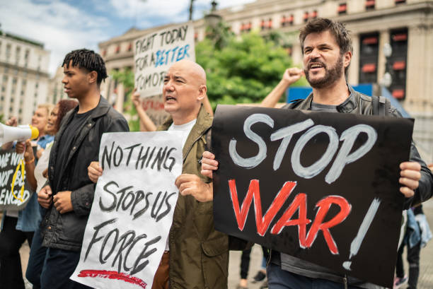 istock Protests holding signs during on a demonstration for peace 1385767134
