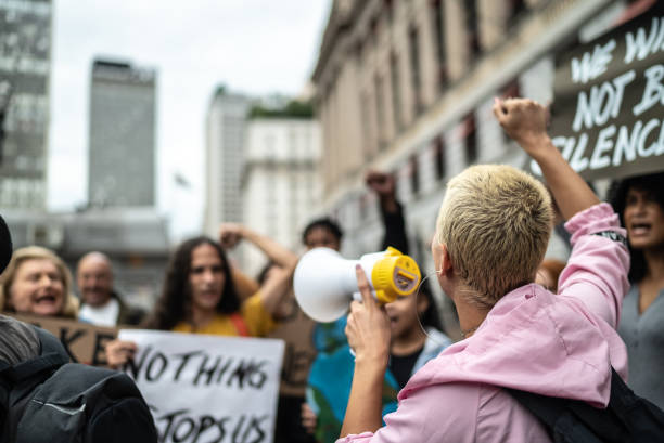 istock Woman shouting through megaphone during on a demonstration outdoors 1385767144