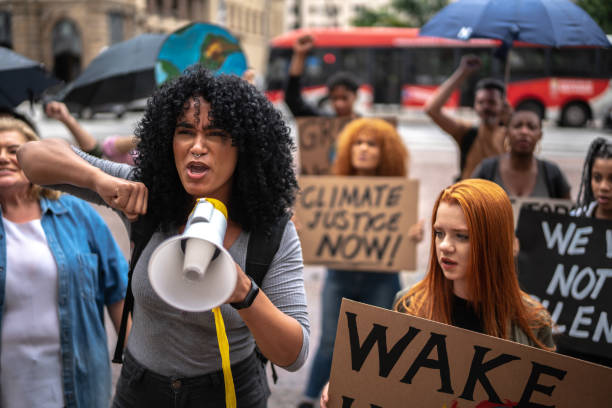 istock Young woman leading a demonstration using a megaphone 1385767340