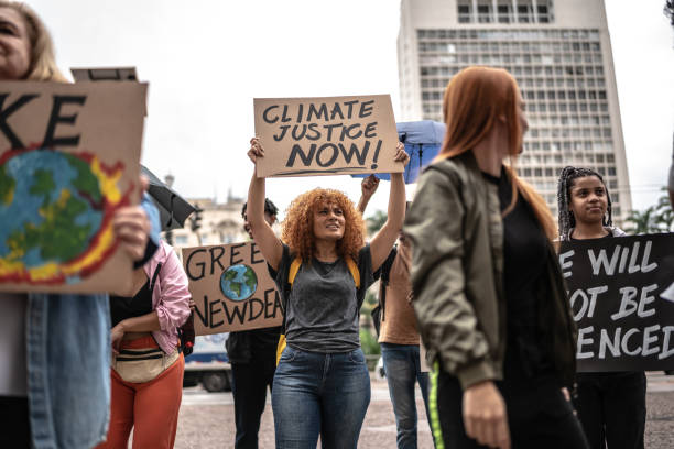 Protests holding signs during on a demonstration for environmentalism