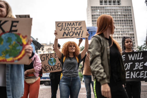 Protests holding signs during on a demonstration for environmentalism Protests holding signs during on a demonstration for environmentalism climate justice stock pictures, royalty-free photos & images