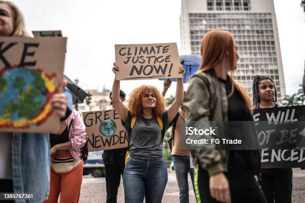 Protests Holding Signs During On A Demonstration For Environmentalism Stock Photo - Download Image Now
